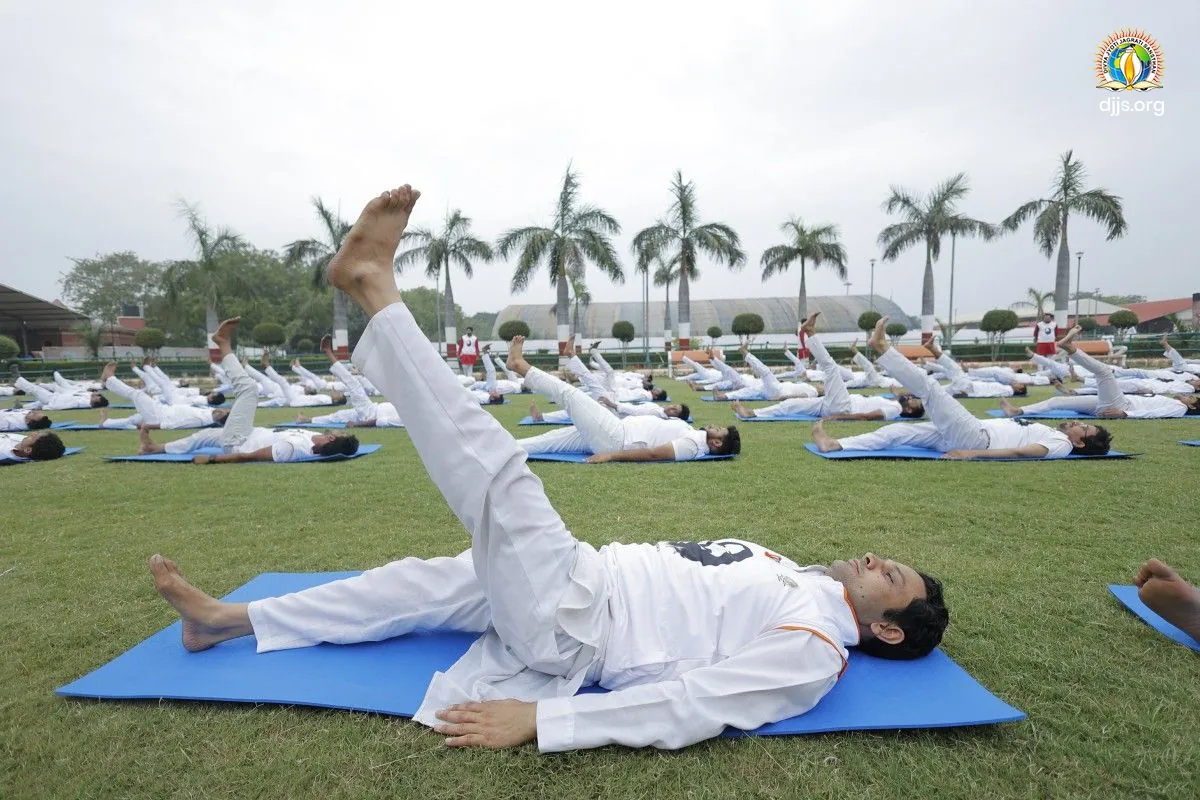 Yoga on the palm-fringed lawn of Divya Dham Ashram on International Yoga Day 2023